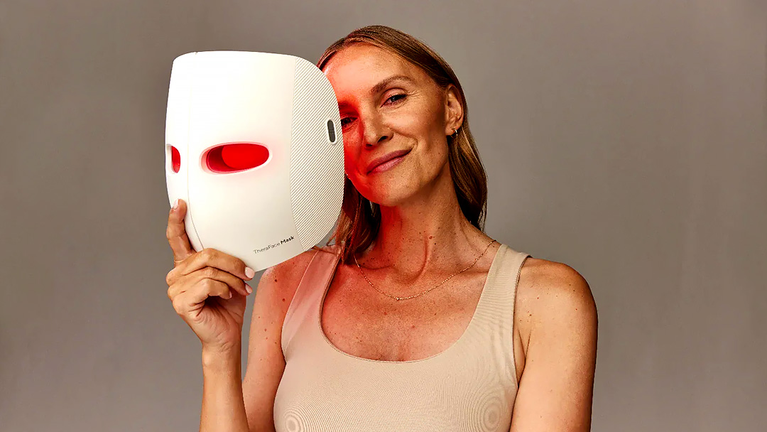 Best red light therapy mask: A woman holding her TheraFace mask.