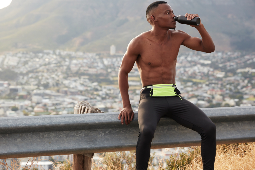 Best peptides for weight loss: man runner drinking water.