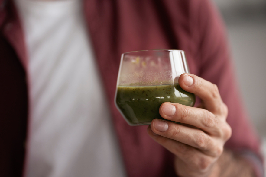 Best peptides for weight loss: a man drinking some green healthy drink.