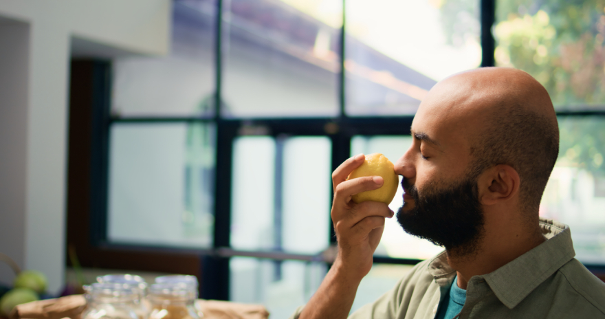 Best peptides for weight loss: a man sniffing a lemon.