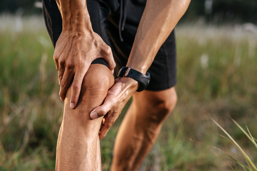 Collagen peptides benefits: a man holding his knee.