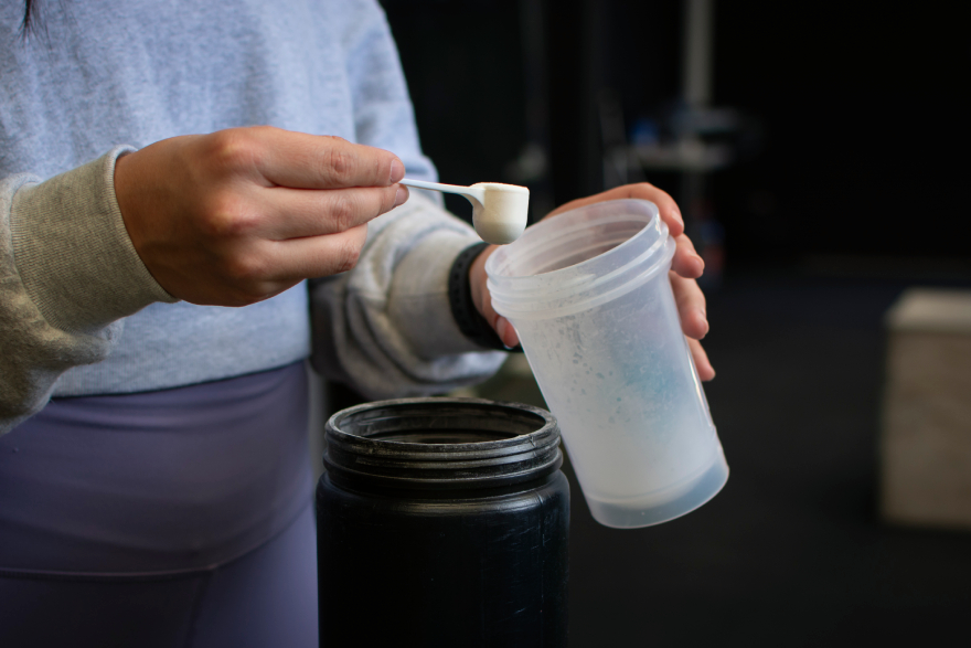 Collagen peptides benefits: a man scooping some powder.