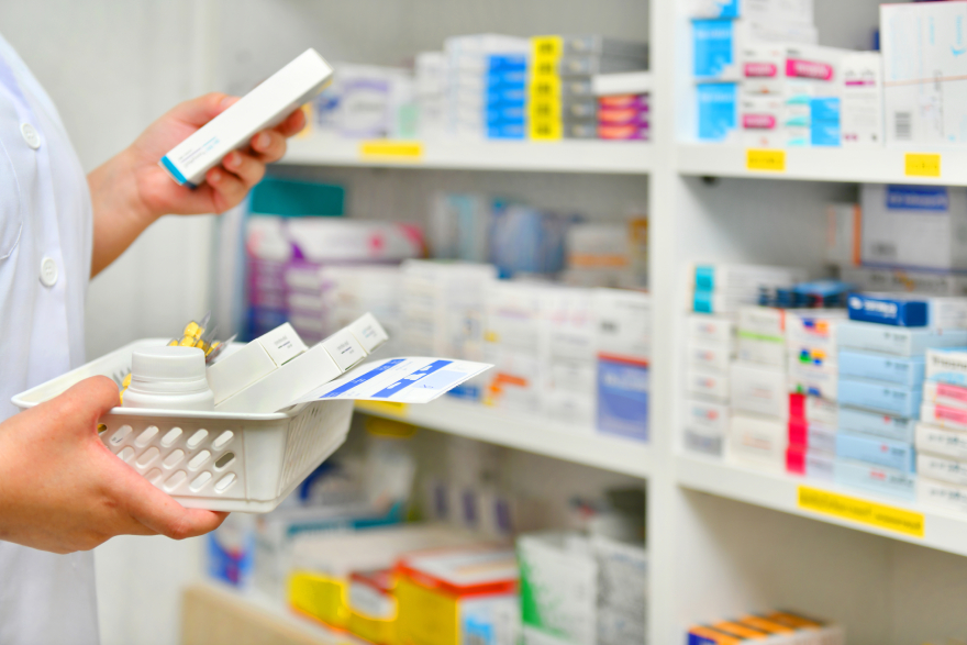 Mounjaro cost: a pharmacist browsing through medicine.