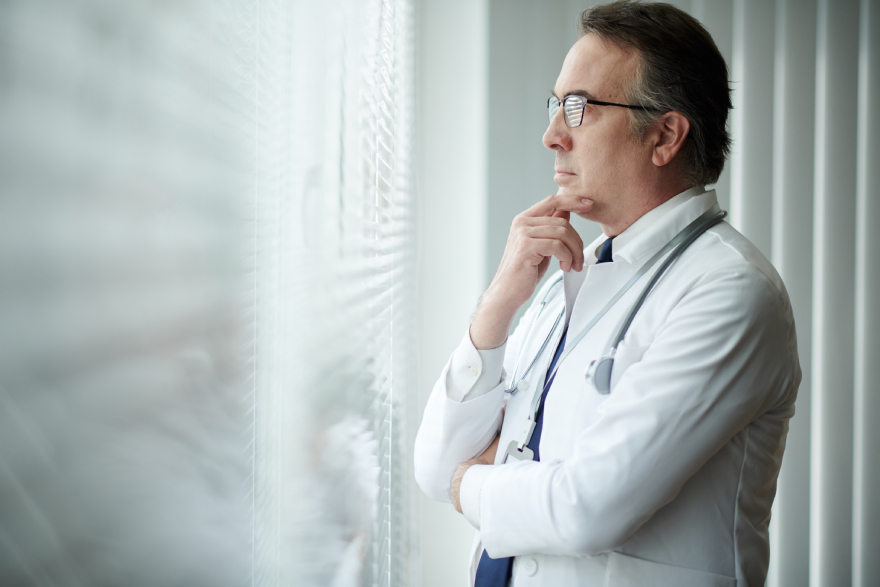 Mounjaro doses: a doctor thinking and looking out the window.