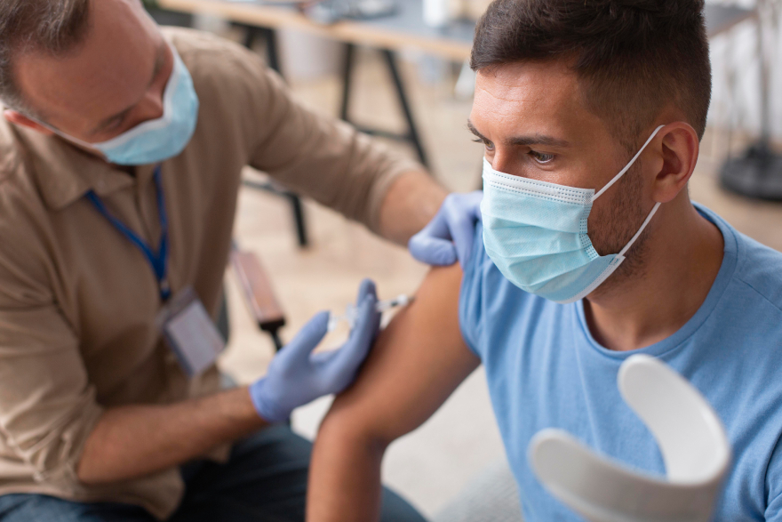 Mounjaro injection sites: a man injecting another man with Mounjaro.