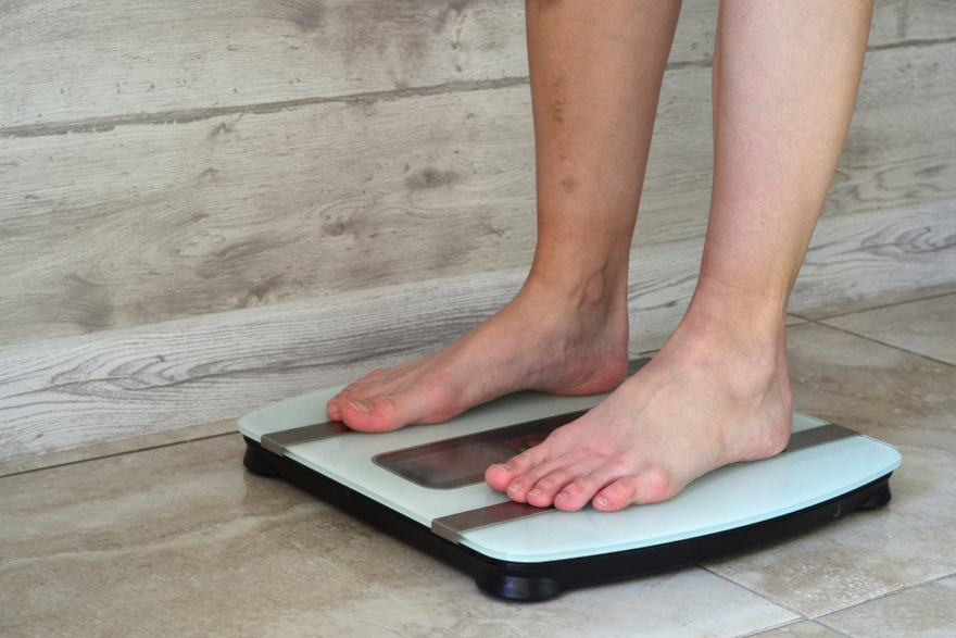 Ozempic alternatives: a girl standing on scales.
