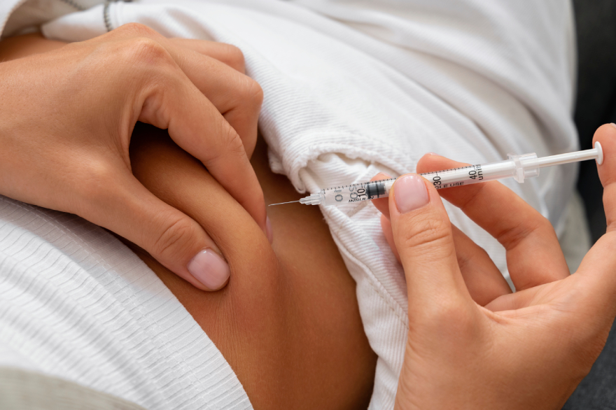 Ozempic vs Wegovy: a woman injecting a peptide into her belly.