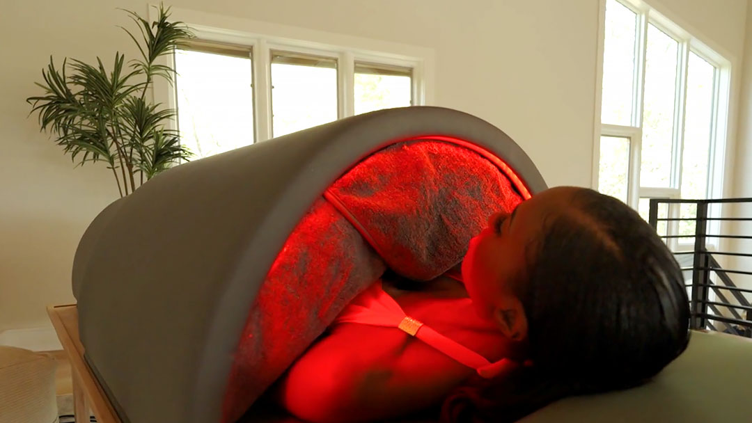 Sauna benefits: a woman using the Sunlighten Solo sauna.