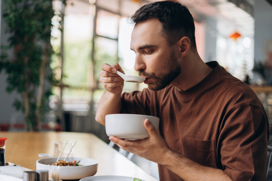 Wegovy vs Mounjaro: a man eating.