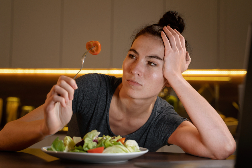 Wegovy vs Mounjaro: a woman not eating her food.