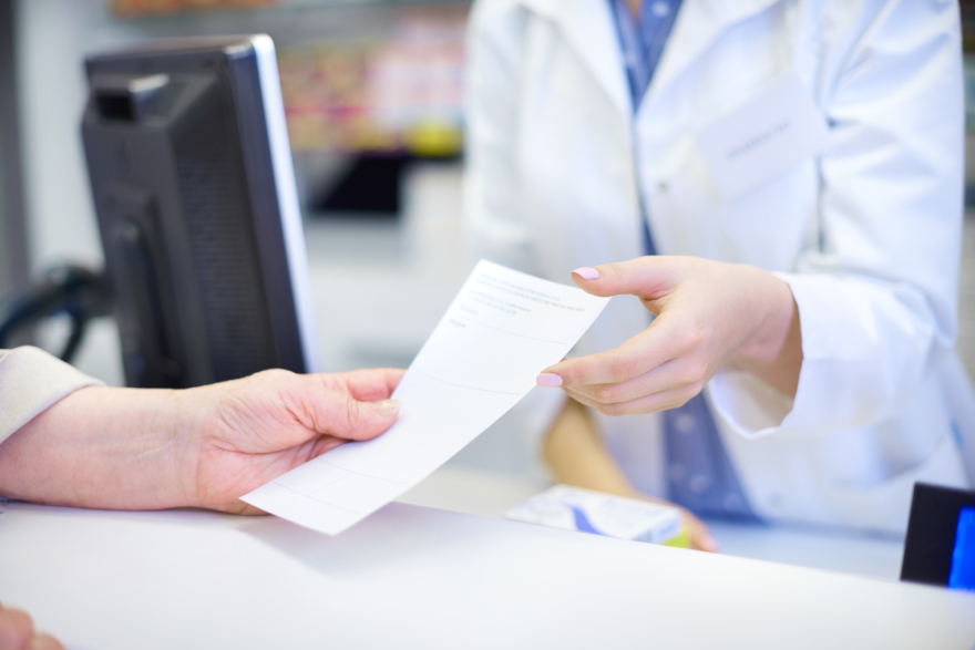 Zepbound vs Mounjaro: a person handing over a doctor's prescription.