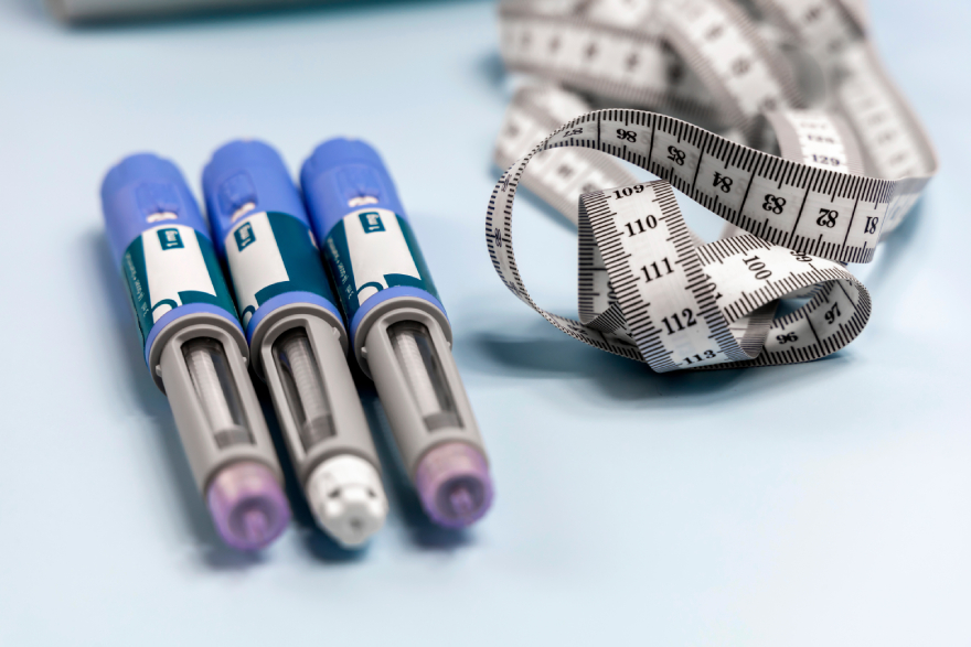 Zepbound vs Mounjaro: injection pens near a body measuring tape.
