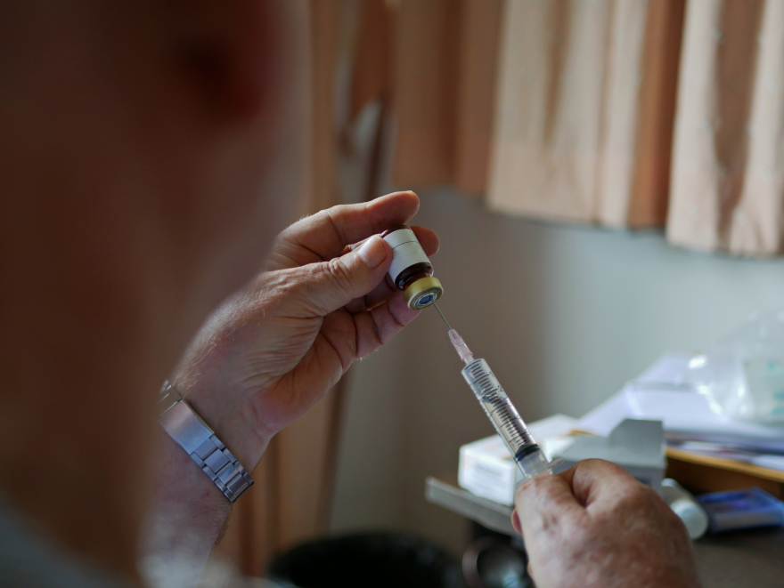 Zepbound vs Mounjaro: a man dosing medicine.
