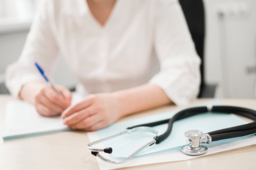 Zepbound vs Mounjaro: medical insurance worker writing on a piece of paper.